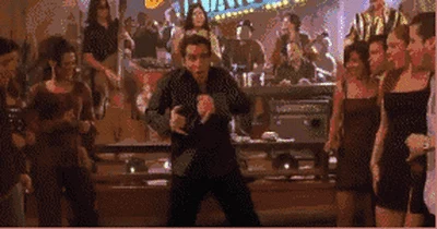People dancing at a lively Spanish-style party
